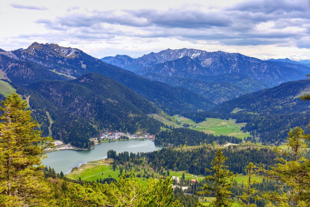 a scenic view of a lake surrounded by mountains