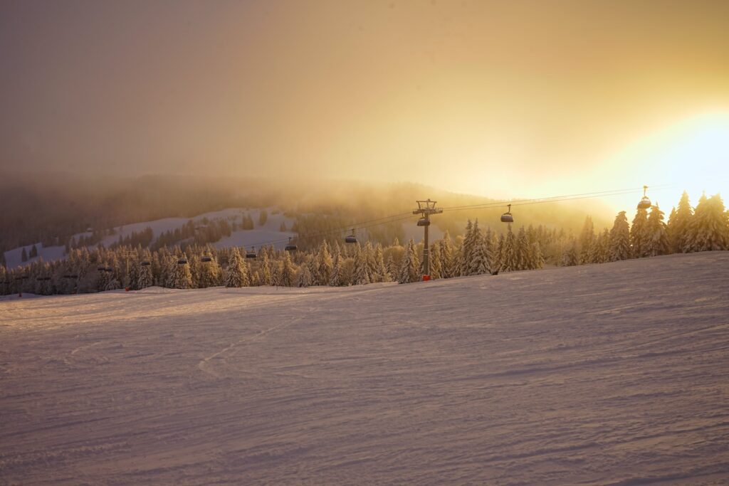 a person riding a snowboard down a snow covered slope